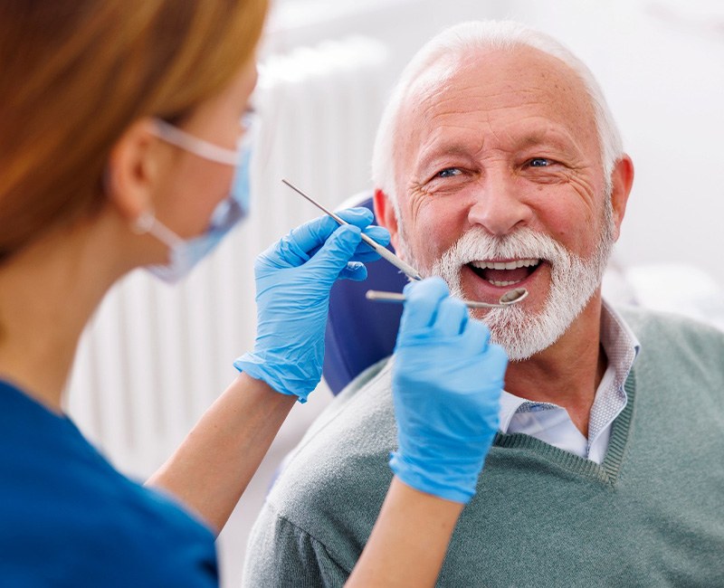 Man smiles at dental hygienist