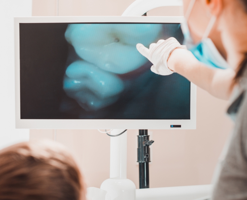 Dentist and patient looking at images captured by intraoral camera