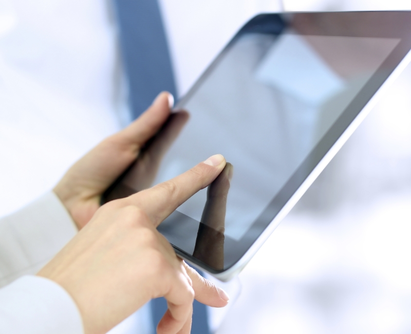 Patient using tablet computer to file dental insurance claim