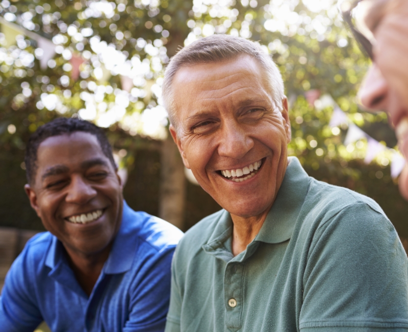 Man with flawless smile after dental implant supported tooth replacement