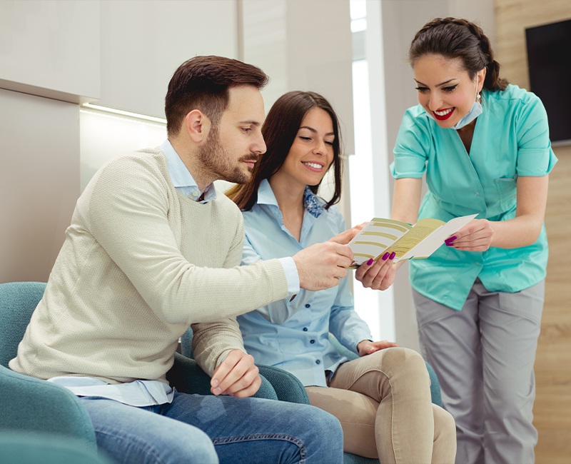 Patients and team member reviewing dental insurance coverage