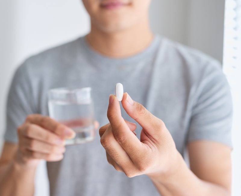 Patient holding an oral conscious dental sedation pill