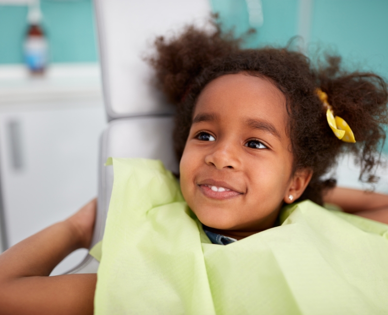 Child smiling during dental checkup and teeth cleaning for kids visit