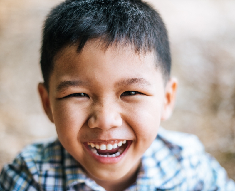 Child laughing after receiving tooth colored fillings