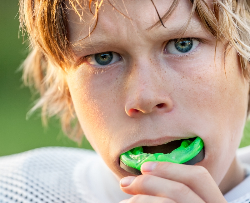 Teen placing protective sportsguard