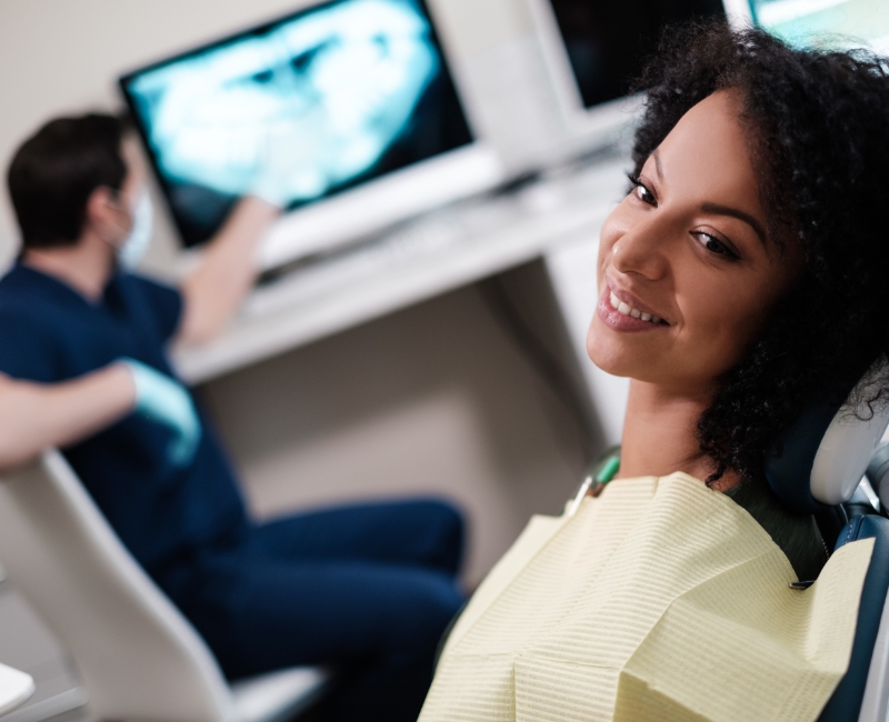 Woman smiling during dental checkup and teeth cleaning visit