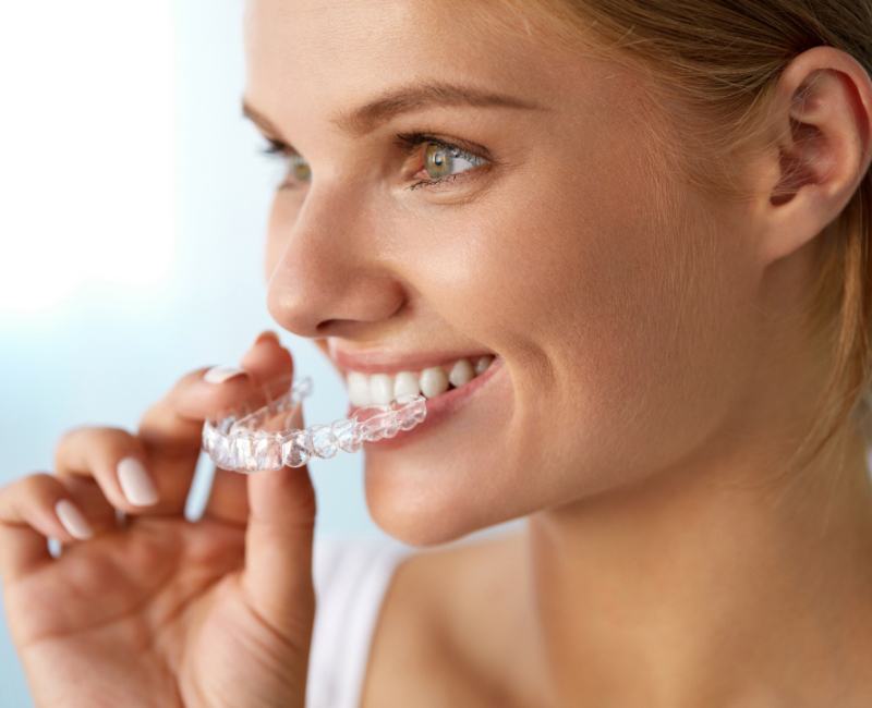 Woman placing Clear Correct clear aligner tray