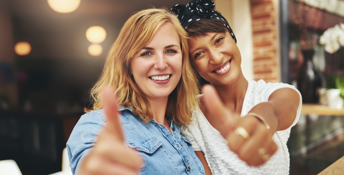 Two women with flawless smiles after cosmetic dentistry