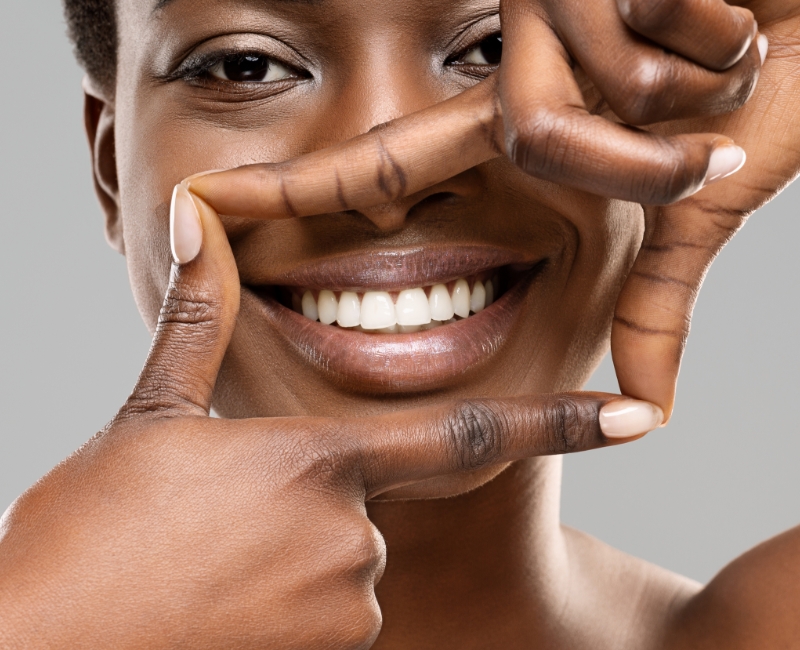 Patient showing off bright smile after teeth whitening