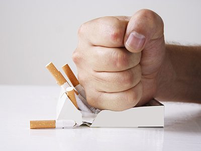 Man crushing cigarettes