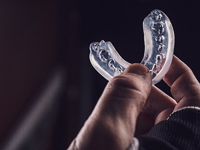 Athlete holding a mouthguard