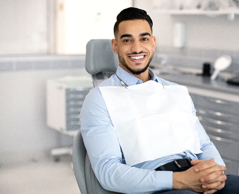 male patient smiling in dental chair and smiling