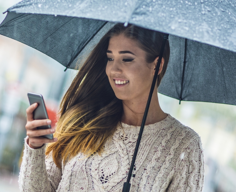 Woman reviewing dental insurance information on her smartphone