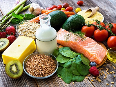 Various healthy foods on a brown wooden surface