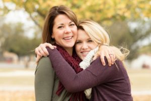 A mother and daughter smiling.