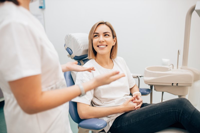 Patient talking to dentist at routine appointment