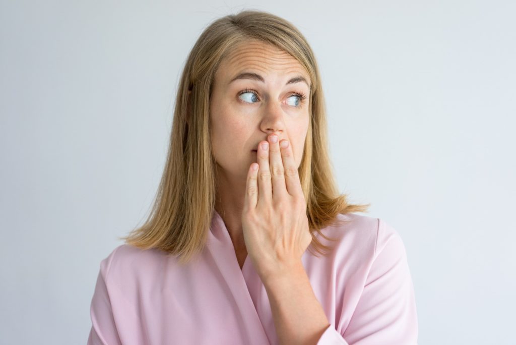 Closeup of woman in pink robe looking concerned