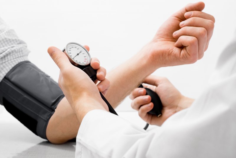 Doctor taking patient's blood pressure