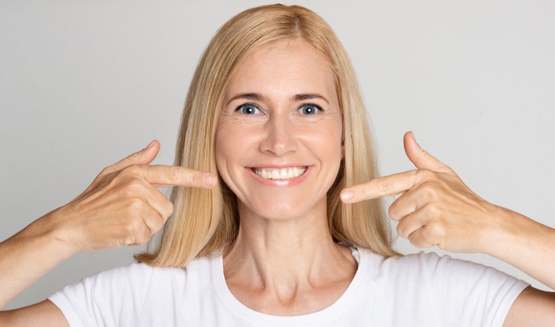 woman smiling with good oral health in Rochester