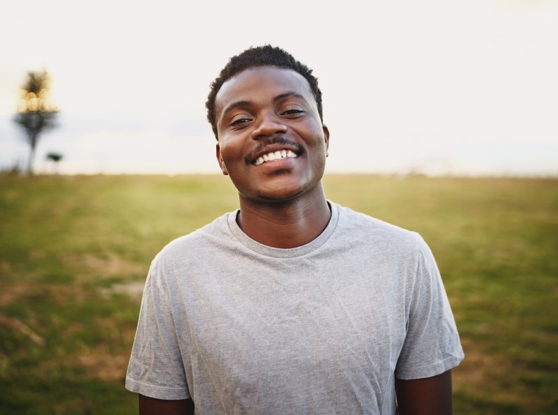Smiling man standing in a field