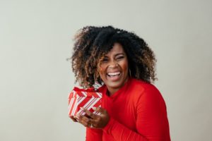 a woman smiling happily during the holiday season